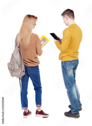 Back view of couple in sweater with mobile phone.