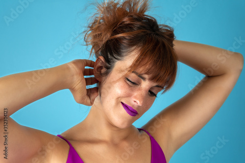Young woman with red hair scratching vigorously her scalp and sh