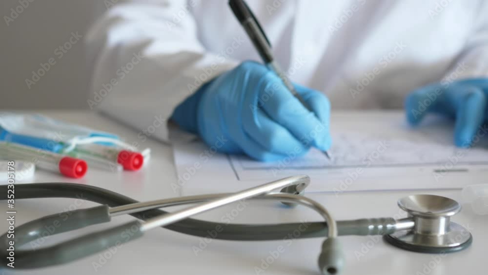 doctor works working at desk in protective gloves, hands of doctor panning shot doctor works working at desk in protective gloves, hands of doctor panning shot