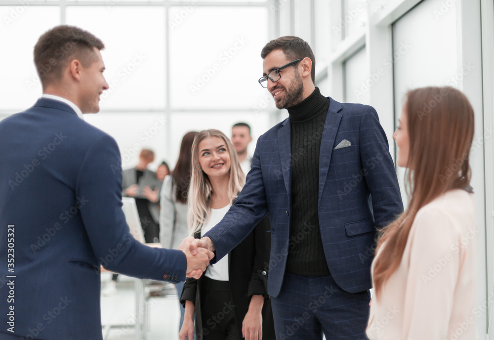happy business people shaking hands with each other. happy business people shaking hands with each other.