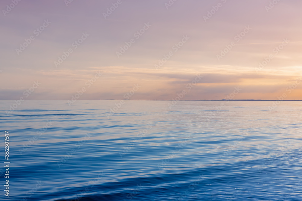 Beautiful light sunset over Baltic sea. Natural background. Latvia. Afterglow, evening calm on the Sea