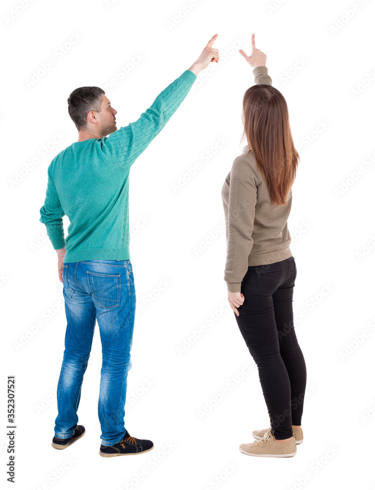Fototapeta premium Back view of couple in sweater with mobile phone.