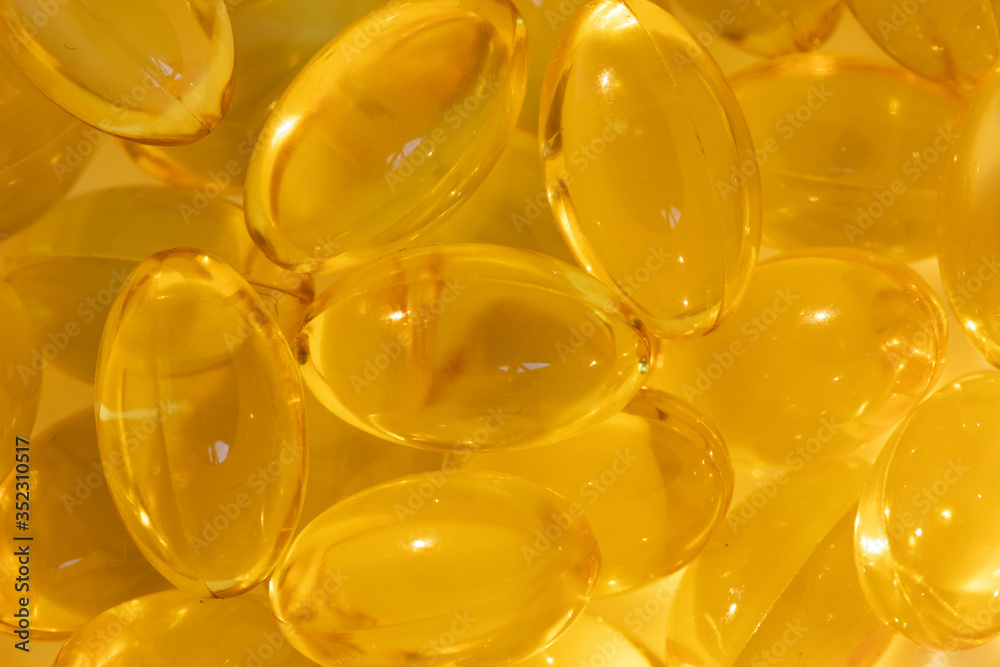 Beautiful yellow transparent pills closeup. Medical concept Beautiful yellow transparent pills closeup. Medical concept