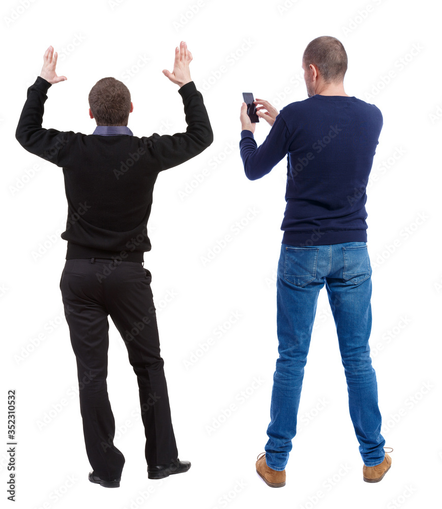 Back view of two man in sweater with mobile phone. Back view of two man in sweater with mobile phone.
