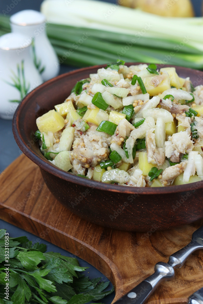 Salad with potatoes, mackerel and celery, seasoned with mustard and olive oil, Vertical format Salad with potatoes, mackerel and celery, seasoned with mustard and olive oil, Vertical format