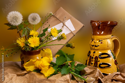 Bouquet of dandelions in a clay yellow vase. Dandelions close-up.  photo