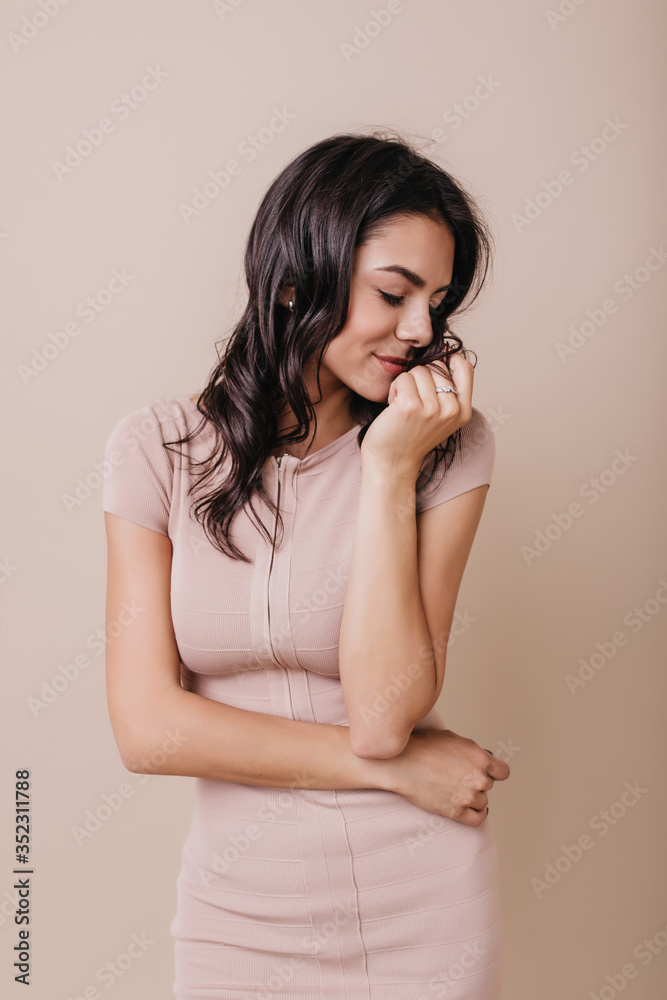 Romantic girl in beautiful dress shyly turns her head. Portrait of brunette in high spirits Romantic girl in beautiful dress shyly turns her head. Portrait of brunette in high spirits