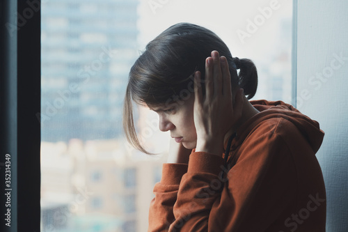 I need silence, mental health, stress, migraine or depression concept, young sad depressed abused frustrated woman at home covering ears with hands having headache