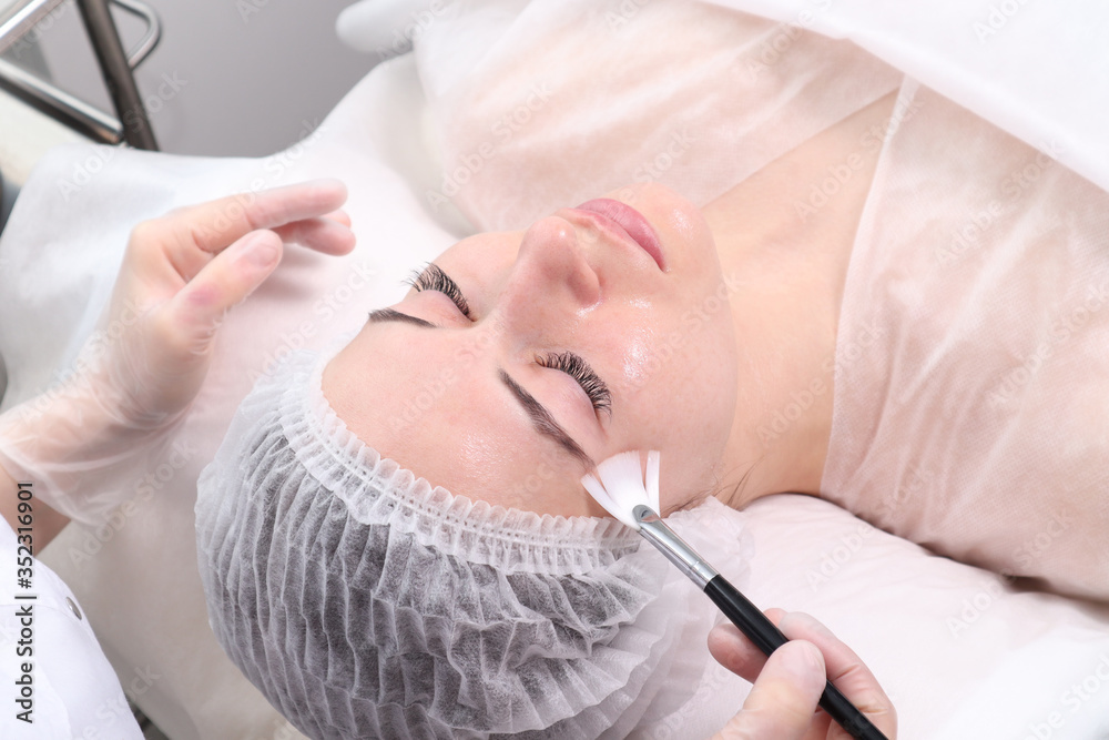The woman on reception at the beautician. Cosmetic procedures for the face and neck. The concept of skin care face and neck The woman on reception at the beautician. Cosmetic procedures for the face and neck. The concept of skin care face and neck