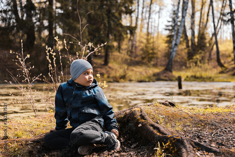 little boy thought about the meaning of life, looking at the water little boy thought about the meaning of life, looking at the water