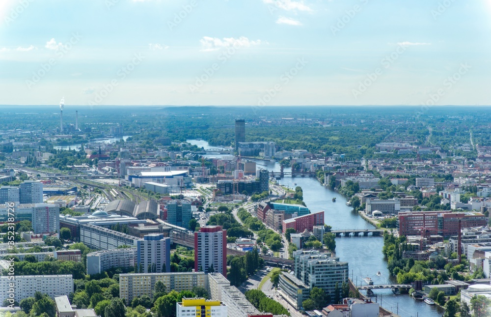 City views of Berlin from a tower in the center of the city during a sunny day in the summer. River view.