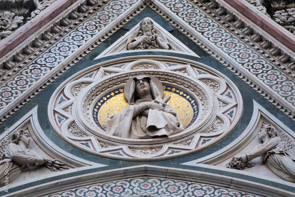 Exterior / facade of the Cathedral of Santa Maria del Fiore in Florence, Italy. Close shot of decoration and art of the front fasade of the cathedral