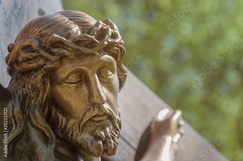 The face of Jesus Christ with a cross and a thorn wreath on the head (religion, Christianity, faith concept)