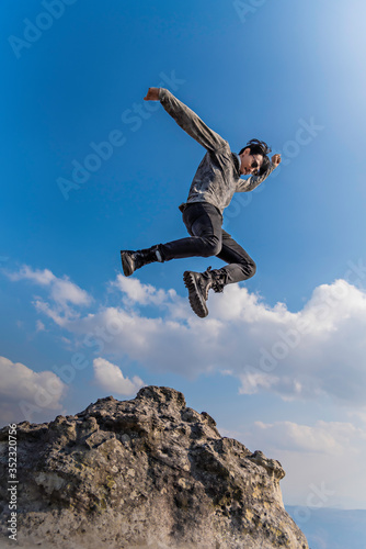 man jumping on the mountain