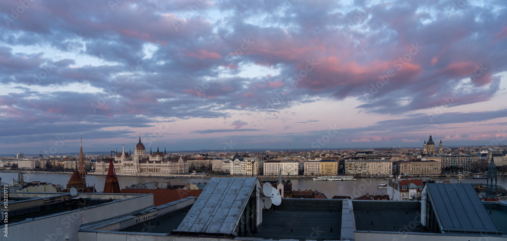 Panoramic view from Pest house balcony of Danube river side with Hungarian Parliament at dusk
