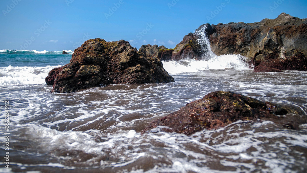 Beautiful seascape of cliffs and rocks in the ocean waves on the shore
