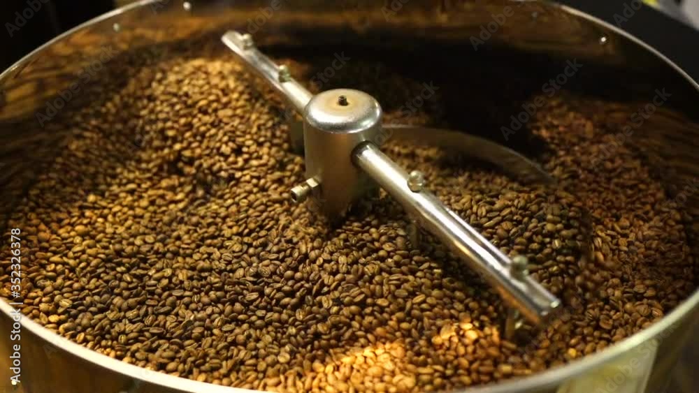 Close up of coffee beans in roaster - Slow motion Close up of coffee beans in roaster - Slow motion