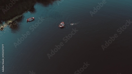 water rescue operation, a man overboard and a rescue service rescues him. The view from the helicopter