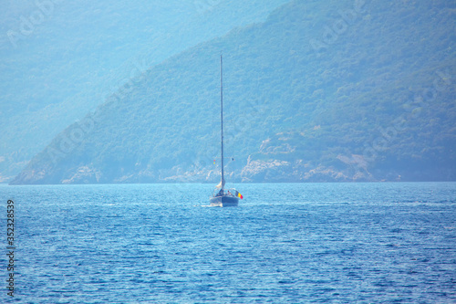 long mast yacht sailing in the sea