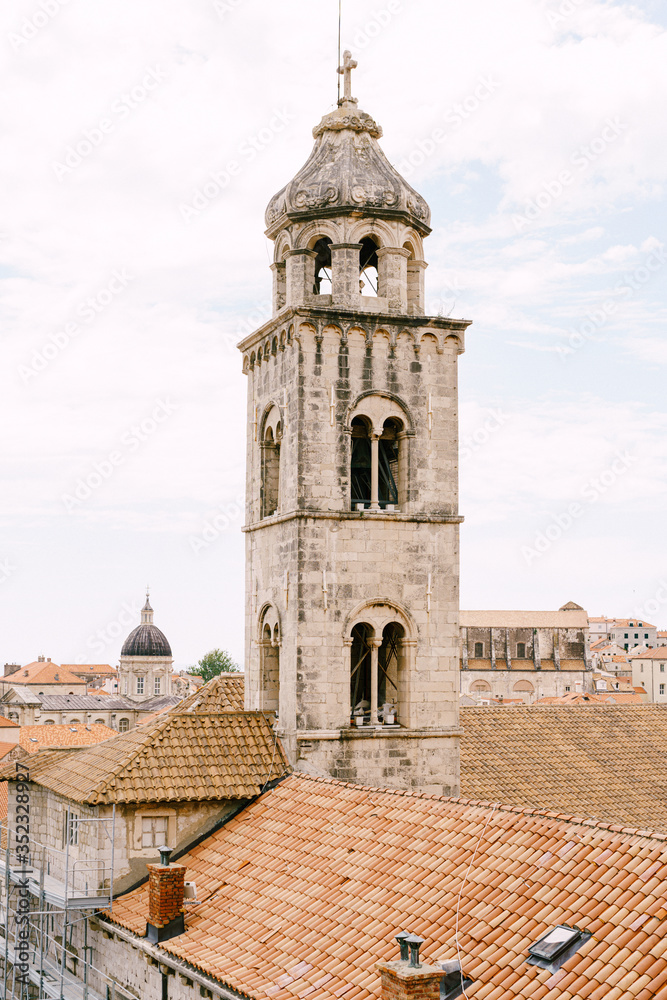 The bell tower of the Dominican monastery on the background of modern Dubrovnik, Croatia.