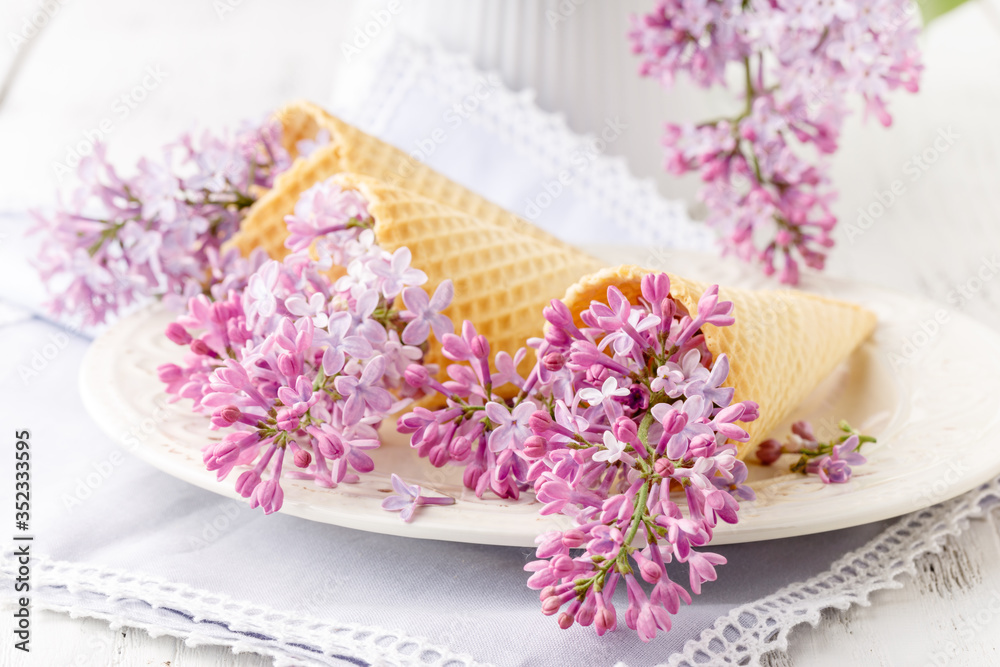 View purple lilacs. Shallow depth of field with lilacs and lilac leaves on wooden table