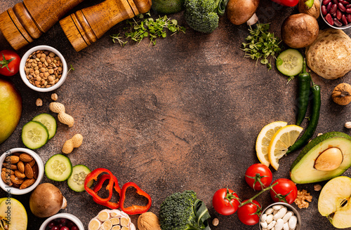 Healthy balanced food. A set of products with calcium and vitamins. Ingredients, tomatoes, avocado, nuts, herbs, mushrooms, peppers. Copyspace. Top view.