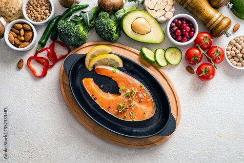 Raw salmon steak in a pan with healthy products. Healthy eating concept, food background. Top view.