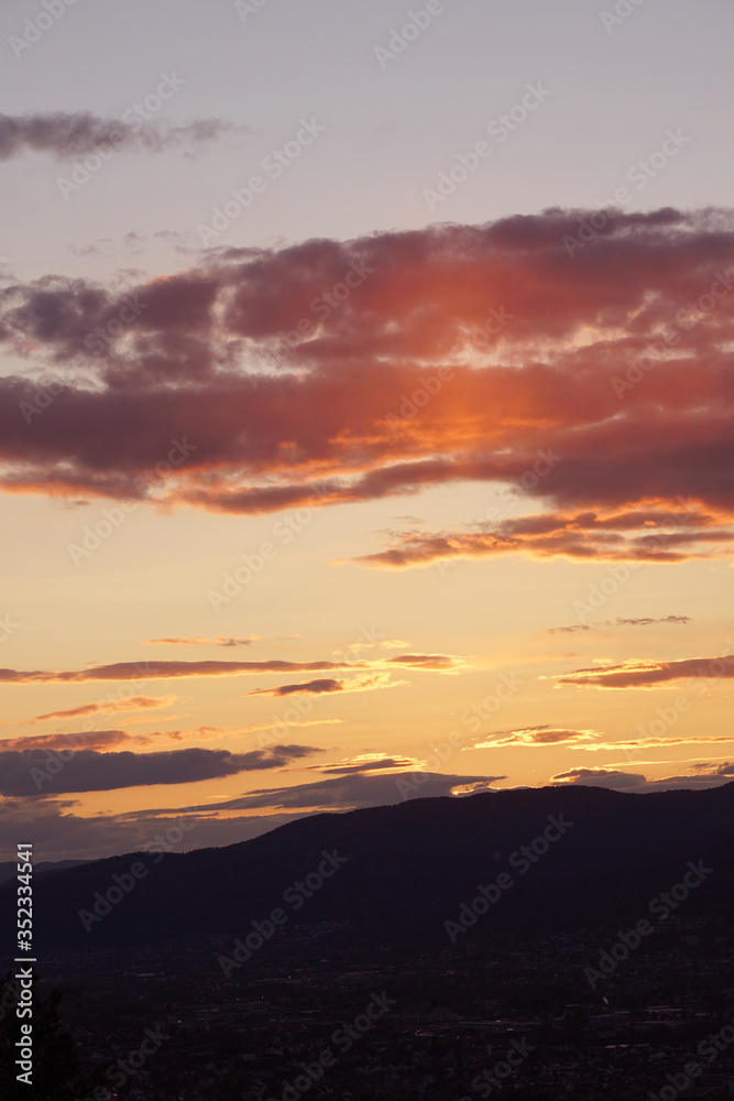Dramatic sky over mountain silhouette. Sunset.