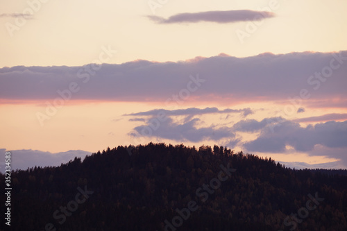 Beautiful colorful sky after sunset over mountains.