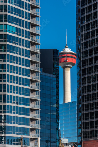 View of the Calgary skyline with modern buildings and the Calgary Tower. 