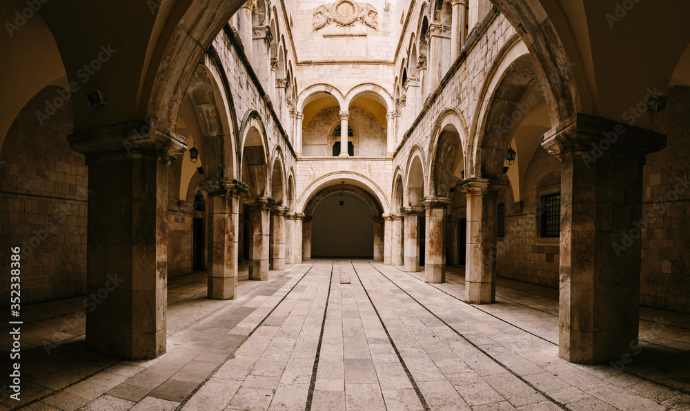 The interior of the Sponza Palace in Dubrovnik, Croatia. Courtyard with columns and open-air arches.