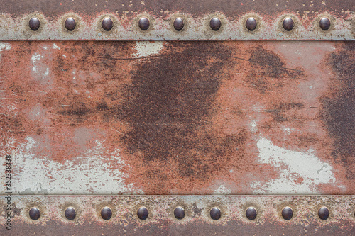 old painted iron plate with shiny rivets
