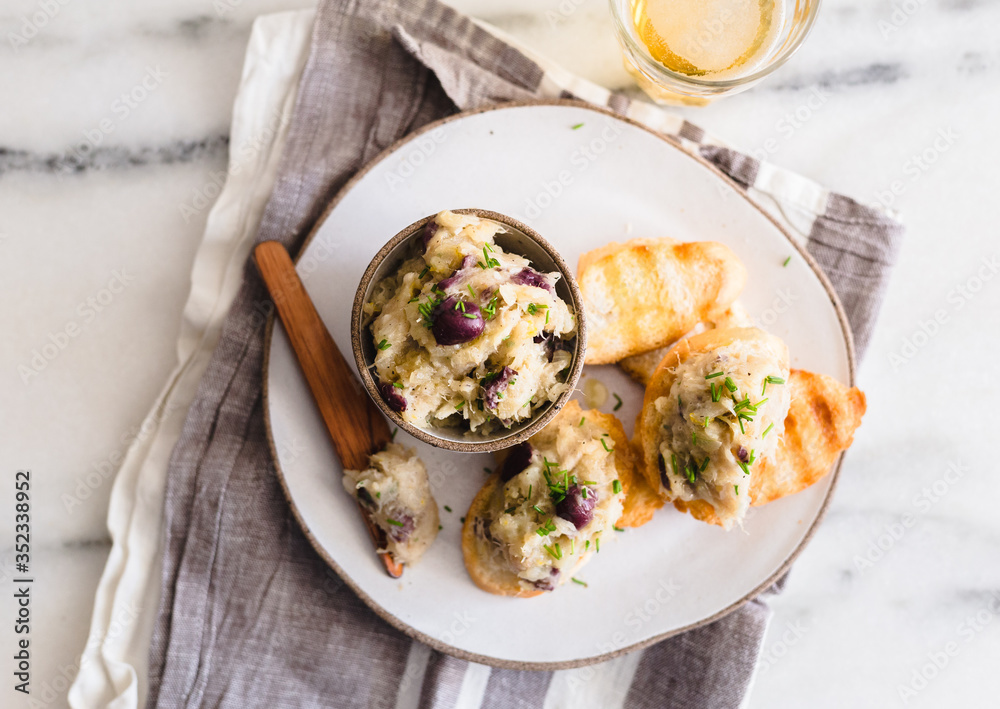 Cod fish brandade on a white ceramic and rustic napkin Stock Photo