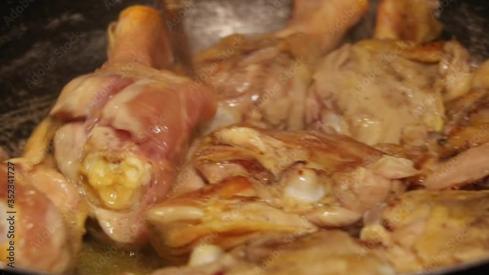 Golden chicken with olive oil in a frying pan Golden chicken with olive oil in a frying pan