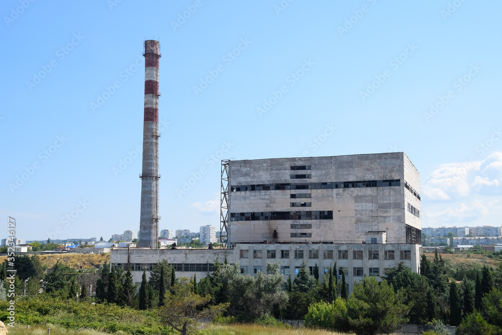 old Soviet factory with a pipe. Abandoned Soviet industry. old Soviet factory with a pipe. Abandoned Soviet industry.