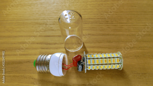 disassembled LED lamp similar to corn with a plastic protective glass.