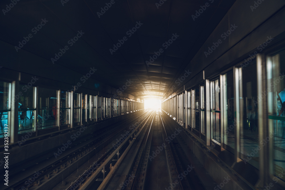 Dubai metro inside, subway station platform, view from train, corridor or tunnel view with perspective.