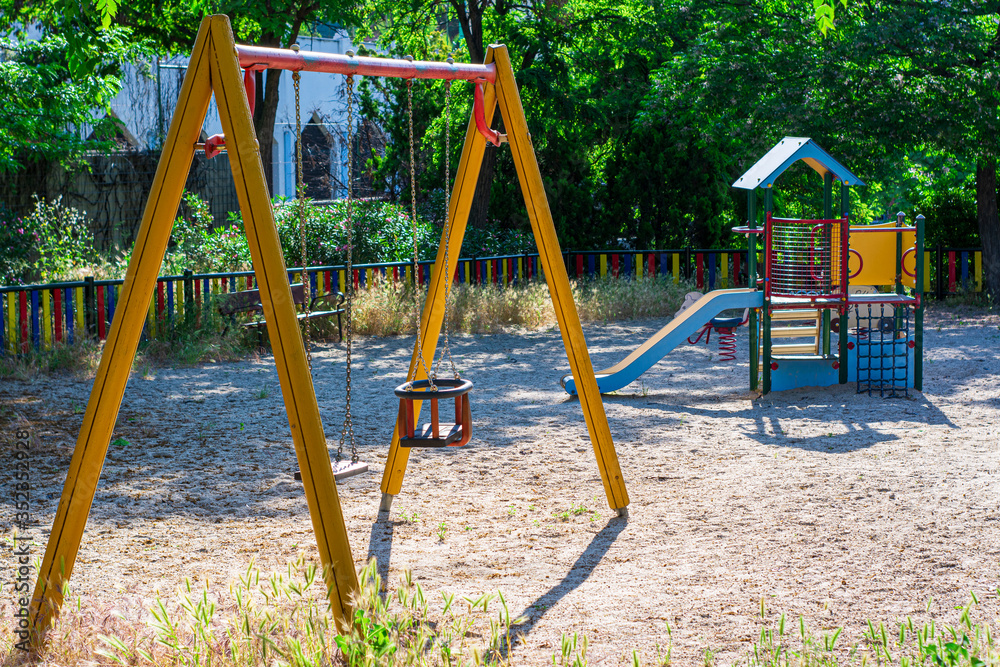 A playground with swing and children slides A playground with swing and children slides