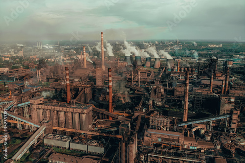Air pollution by smoke from factory chimneys, aerial view. Industrial landscape from drone point of view.