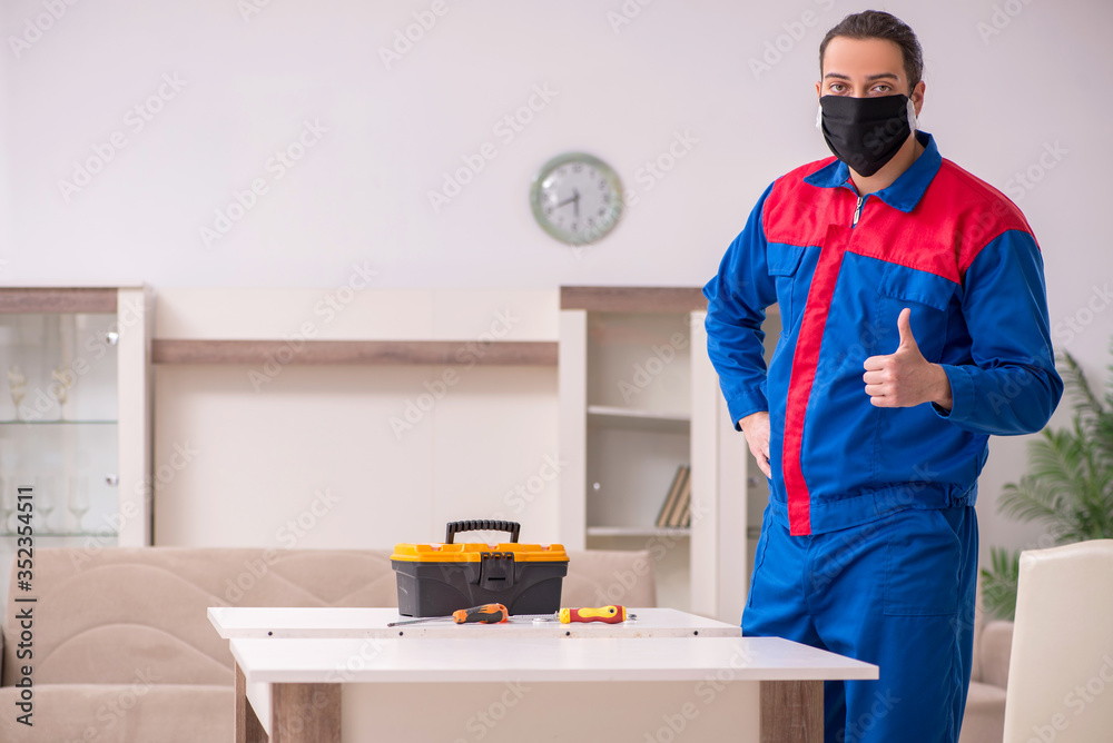 Young carpenter working indoors during pandemic disease Young carpenter working indoors during pandemic disease