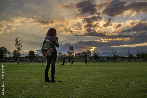 girl watching the sunset in a park © Francisco Díaz
