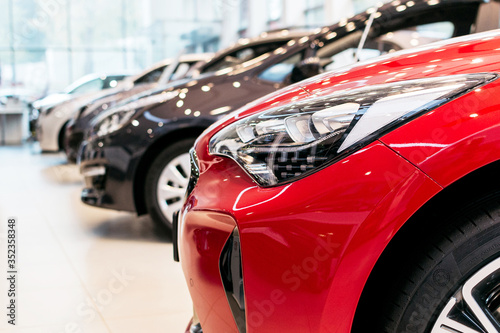 A row of cars in a car dealership