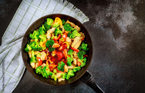 Stir-fry vegetables and chicken with sweet and sour sauce.