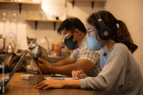 Creative startup designer business worker, working in spaced and wearing a medical face mask To prevent the spread of the coronavirus COVID-2019, Home office for  small people group to work from home