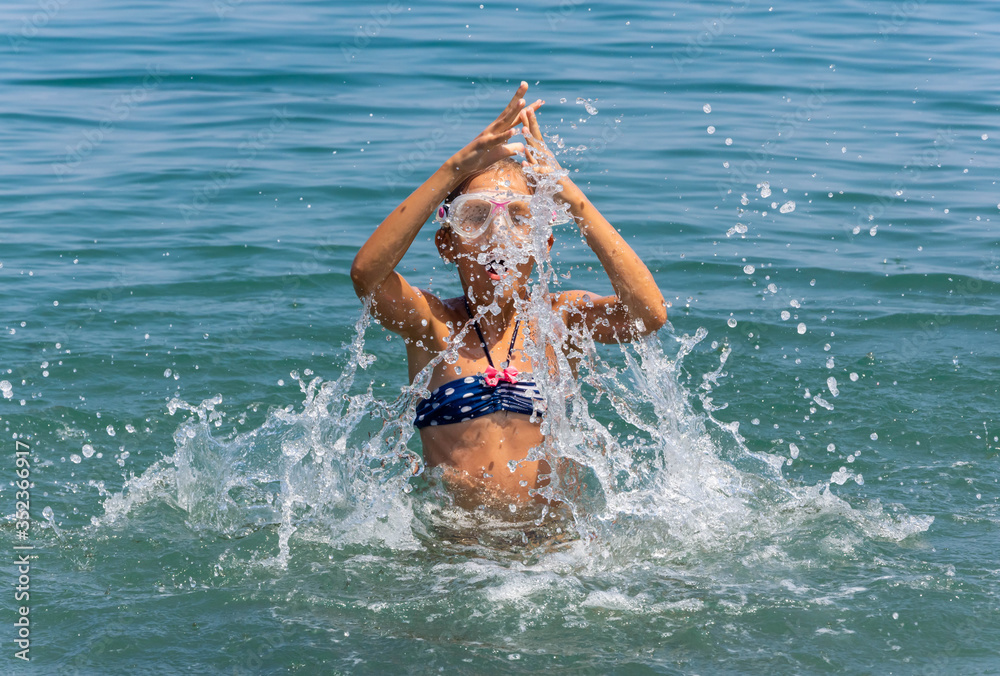 young girl jumping in water