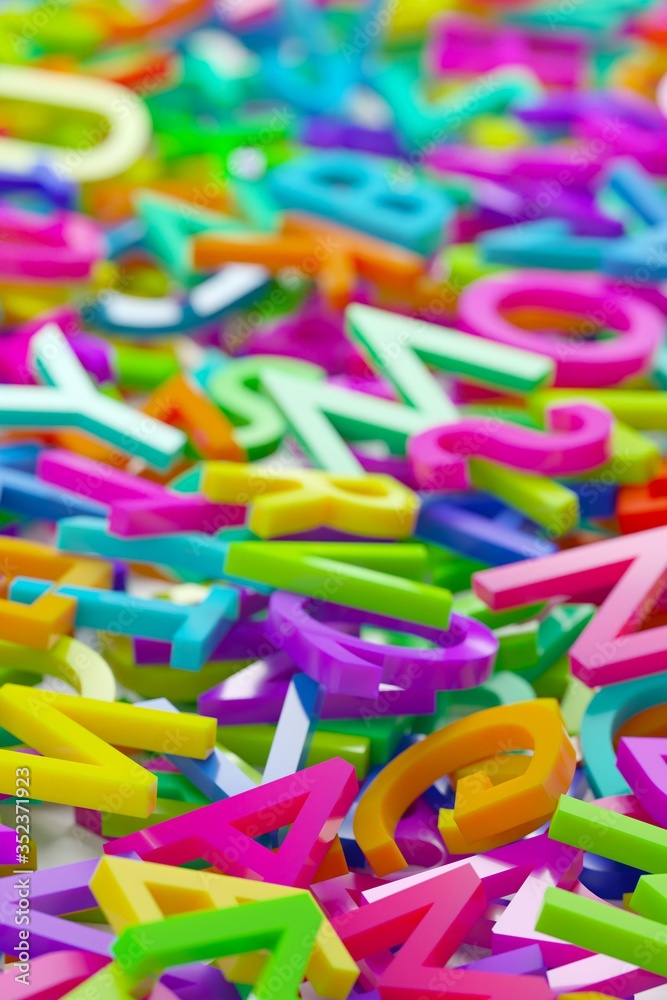 Fototapeta premium Heap of colorful rainbow alphabetic plastic character letters background, literature, education, know-how or writing concept