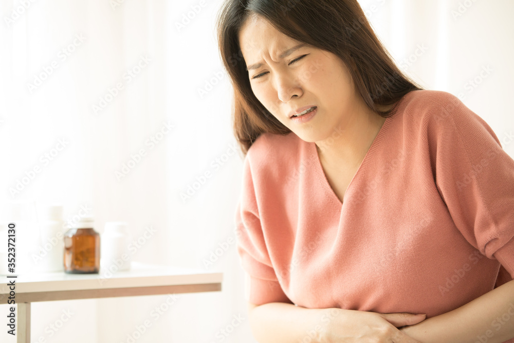 woman have bladder pain sitting on bed in bedroom after wake up feeling so sick and painful,Healthcare concept. woman have bladder pain sitting on bed in bedroom after wake up feeling so sick and painful,Healthcare concept.