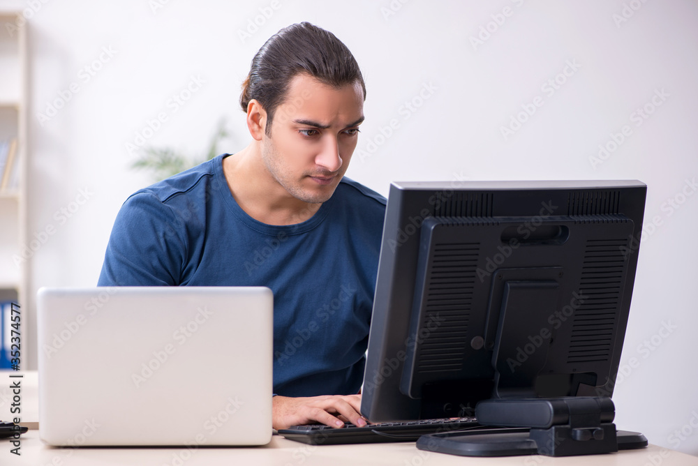Young male it specialist working in the office Young male it specialist working in the office