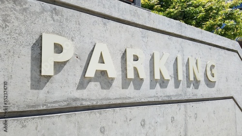 Parking garage signage on building concrete wall