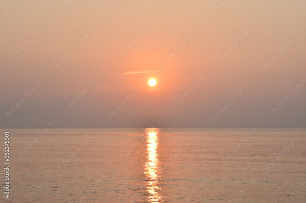 sunrise above the sea. This image is orange